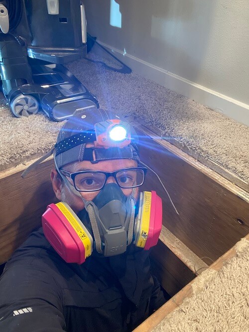 Inspector coming out of a crawlspace